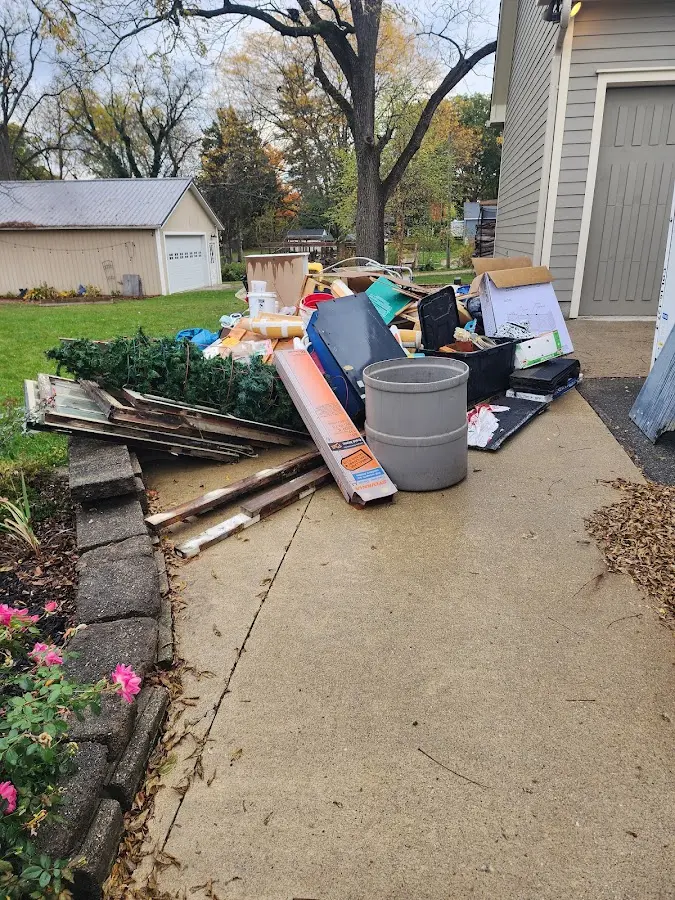 Dumpster being loaded with debris for 10 Yard Dumpster Rental in Ogden